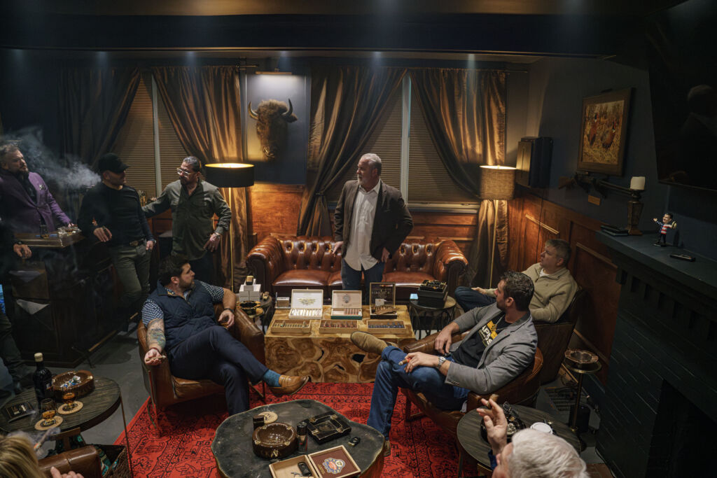 Elegant interior of Kapnós Cigar Lounge with members enjoying cigars.