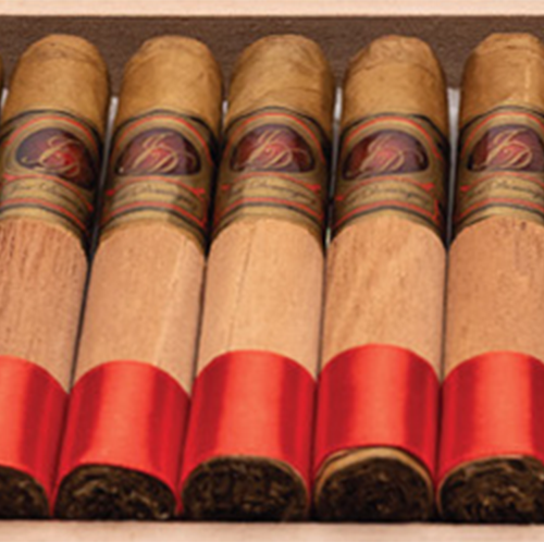 Box of Jose Dominguez Gigante Natural 6x60 cigars, each featuring an Ecuadorian Connecticut wrapper, Indonesian Sumatra binder, and a blend of Dominican and USA Broadleaf fillers. These premium cigars are elegantly wrapped with a cedar sleeve and red foot ribbon, offering a smooth, rich flavor experience perfect for both seasoned aficionados and newcomers to the cigar world.